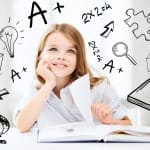 - SoundEnglish Young girl thinking happy thoughts with a book laid out in front of her.